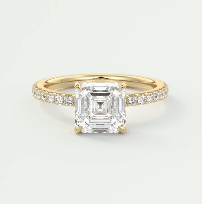 18k yellow gold engagement ring with an asscher-cut diamond and pave-set diamonds on the band.