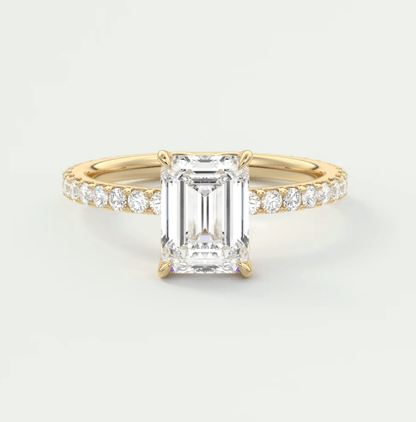 18k yellow gold emerald-cut diamond engagement ring with a channel-set band.
