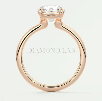 Rose gold diamond engagement ring with a square-cut gemstone and ’diamond lab’ engraving on the band.