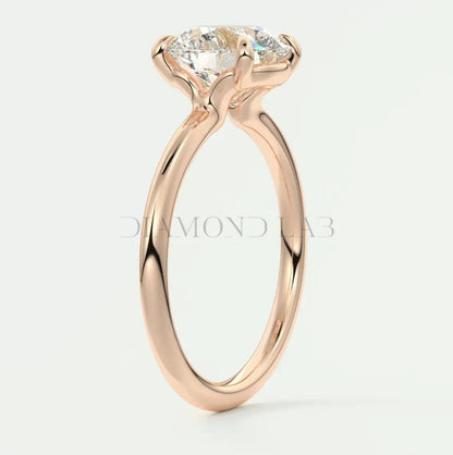 18-karat rose gold engagement ring with a round diamond.