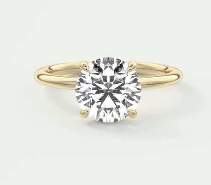 18k yellow gold solitaire diamond engagement ring with a round brilliant cut stone.