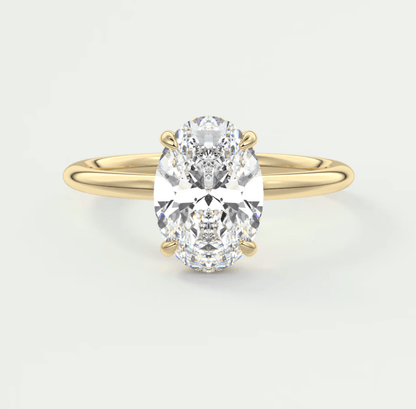18-karat yellow gold oval diamond engagement ring.