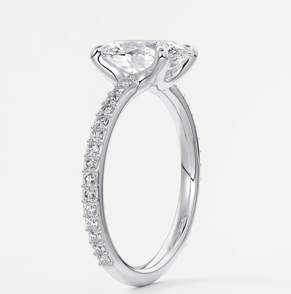 18-karat white gold engagement ring with a princess-cut diamond and pavé-set diamonds on the band.