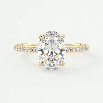 18k yellow gold diamond engagement ring with an oval-cut center stone and pave set diamonds on the band.