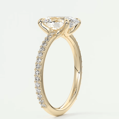 18k yellow gold engagement ring with a marquise-cut diamond and pave-set diamonds on the band.