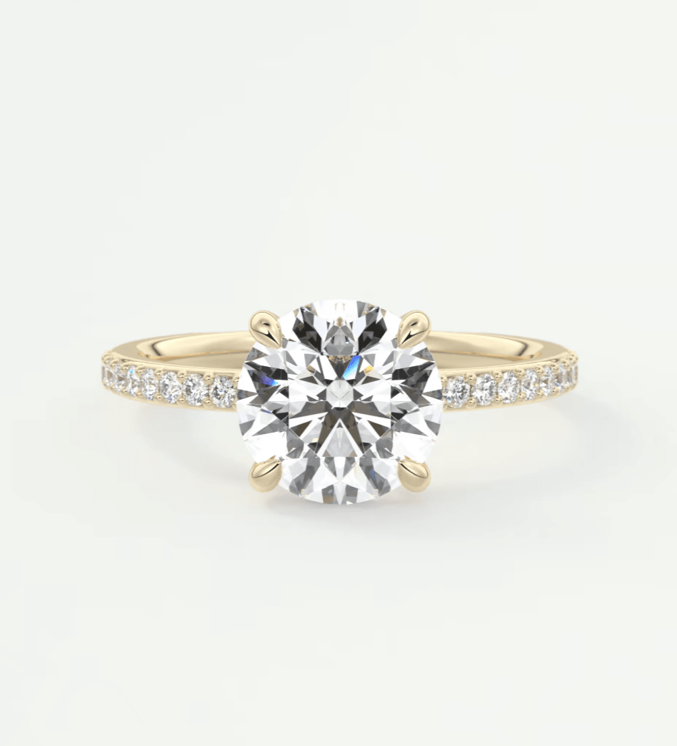 18k yellow gold diamond engagement ring with a round brilliant cut center stone and pave set diamonds on the band.