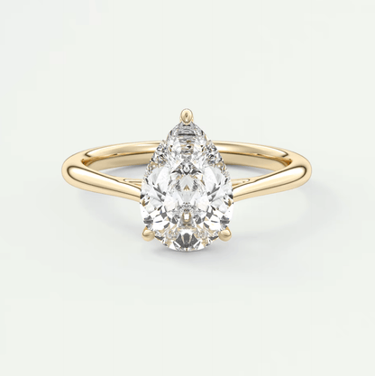 Pear-shaped diamond engagement ring with a yellow gold band and prong setting.