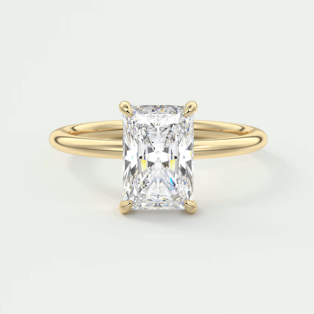 18k yellow gold solitaire engagement ring with a rectangular diamond.