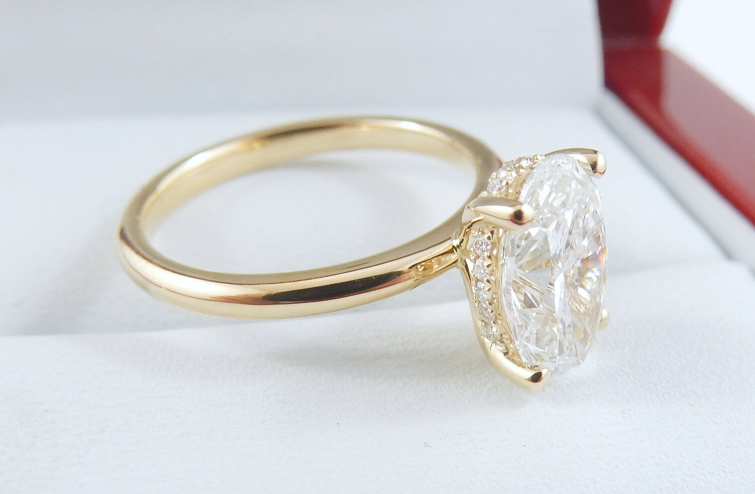 Gold ring with a large diamond on a white background
