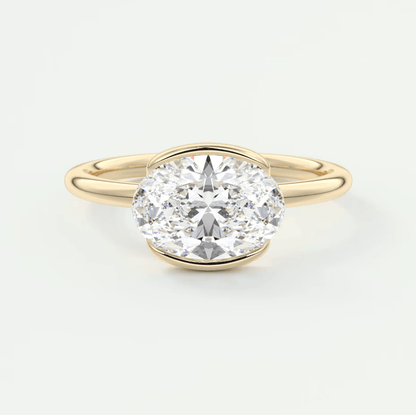 18k yellow gold oval diamond engagement ring with a bezel setting.