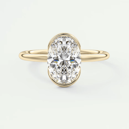 18k yellow gold oval diamond engagement ring with a bezel setting.