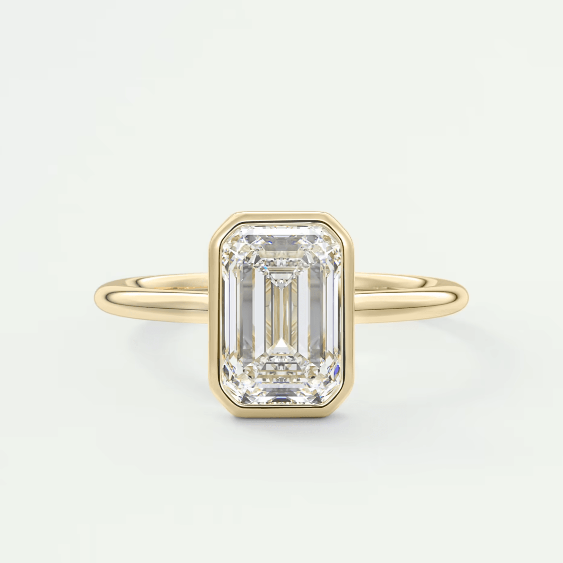 18-karat yellow gold emerald-cut diamond ring.