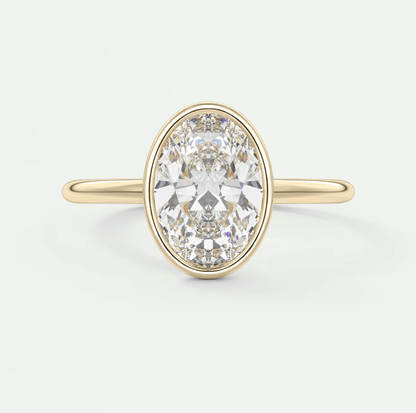 18k yellow gold oval diamond engagement ring with a bezel setting.