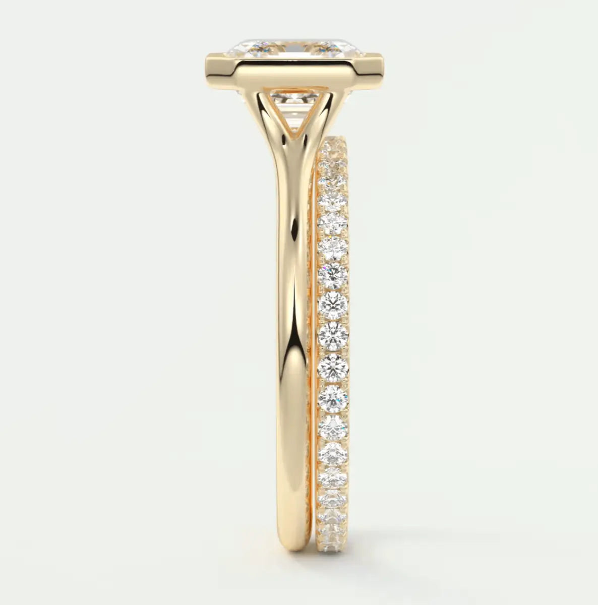 18k yellow gold diamond engagement ring with a princess cut center stone and pavé set diamonds on the band.