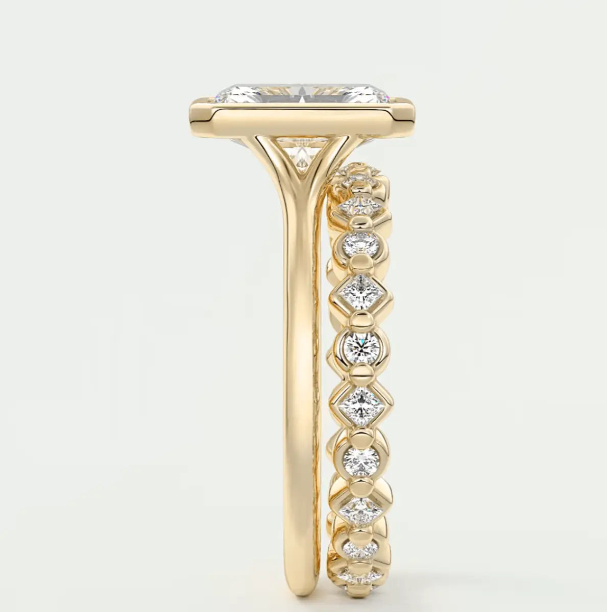 18k yellow gold engagement ring with princess cut diamond center stone and channel set diamonds on the band.