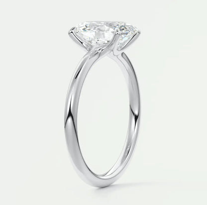 18-karat white gold solitaire engagement ring with a cushion-cut diamond.