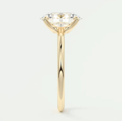 18-karat yellow gold engagement ring with a cushion-cut diamond.