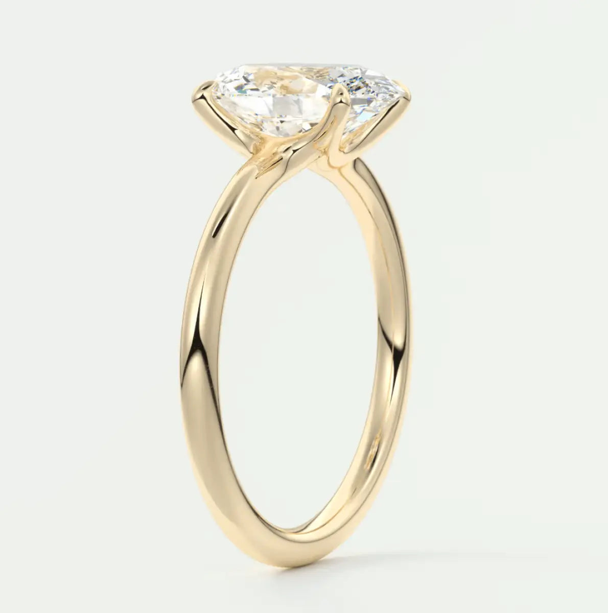 18k yellow gold solitaire engagement ring with a cushion-cut diamond.