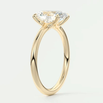 18k yellow gold solitaire engagement ring with a cushion-cut diamond.