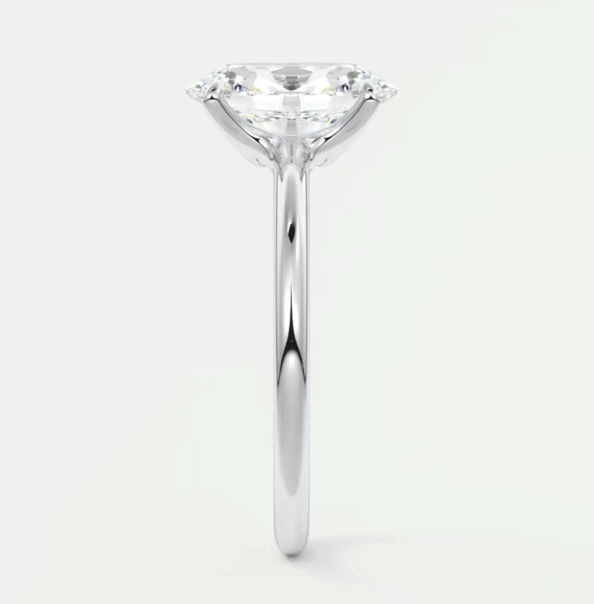 Pear-shaped diamond engagement ring with white gold band and prong setting.