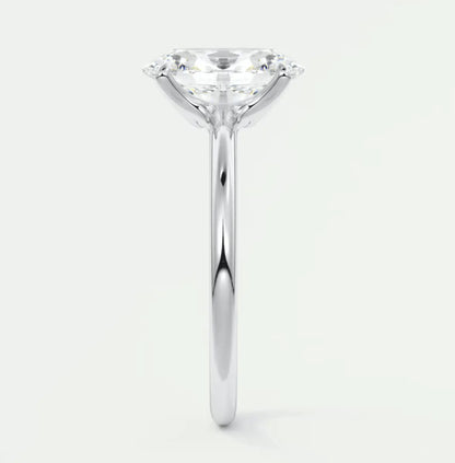 Pear-shaped diamond engagement ring with white gold band and prong setting.