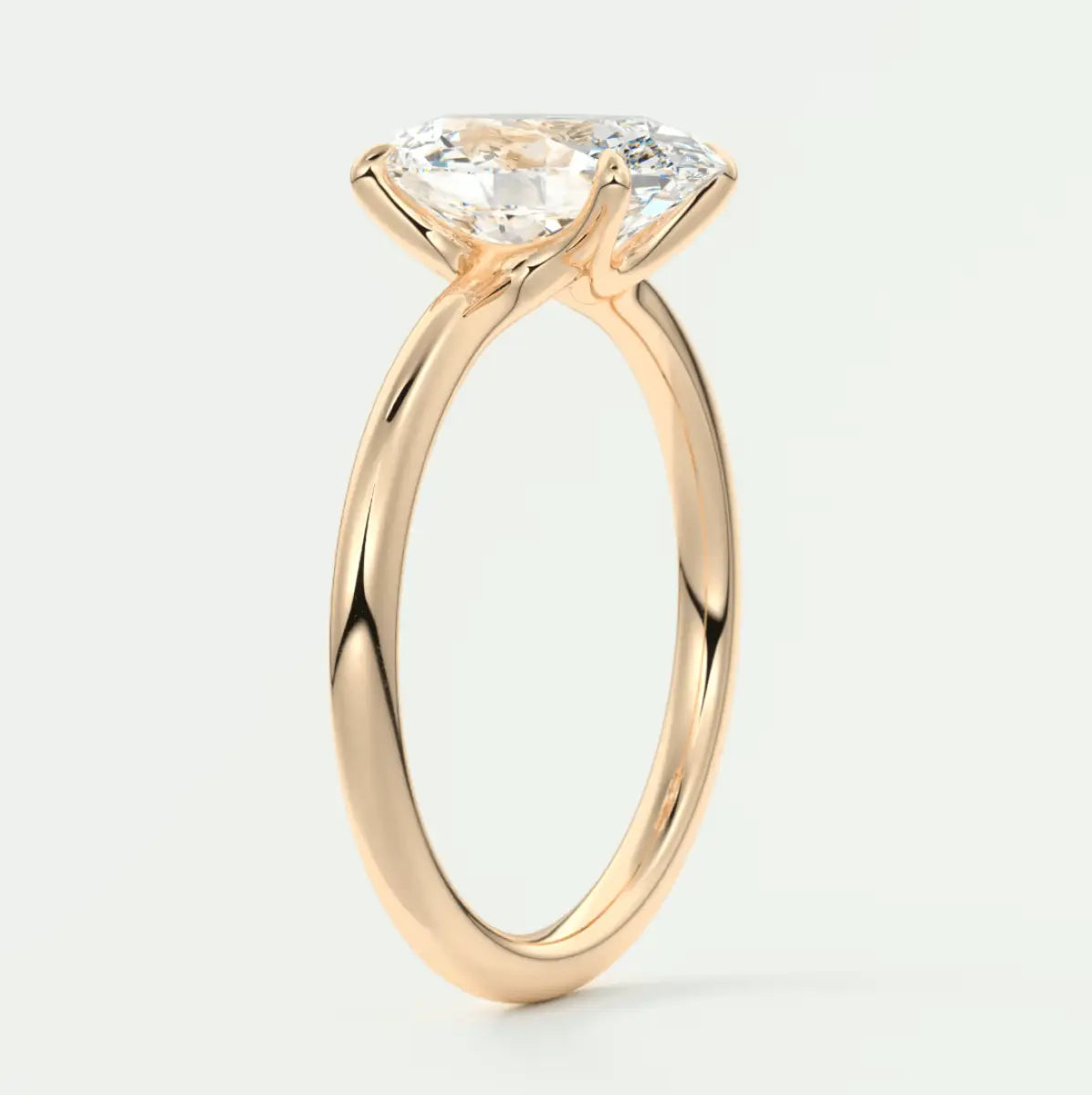 Rose gold engagement ring with a large, cushion-cut diamond.