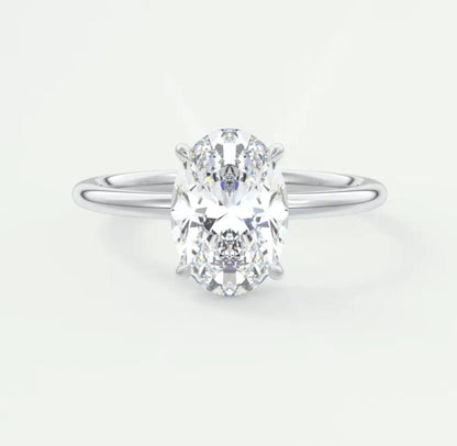 18-karat white gold oval diamond engagement ring with a princess cut center stone and two side diamonds.