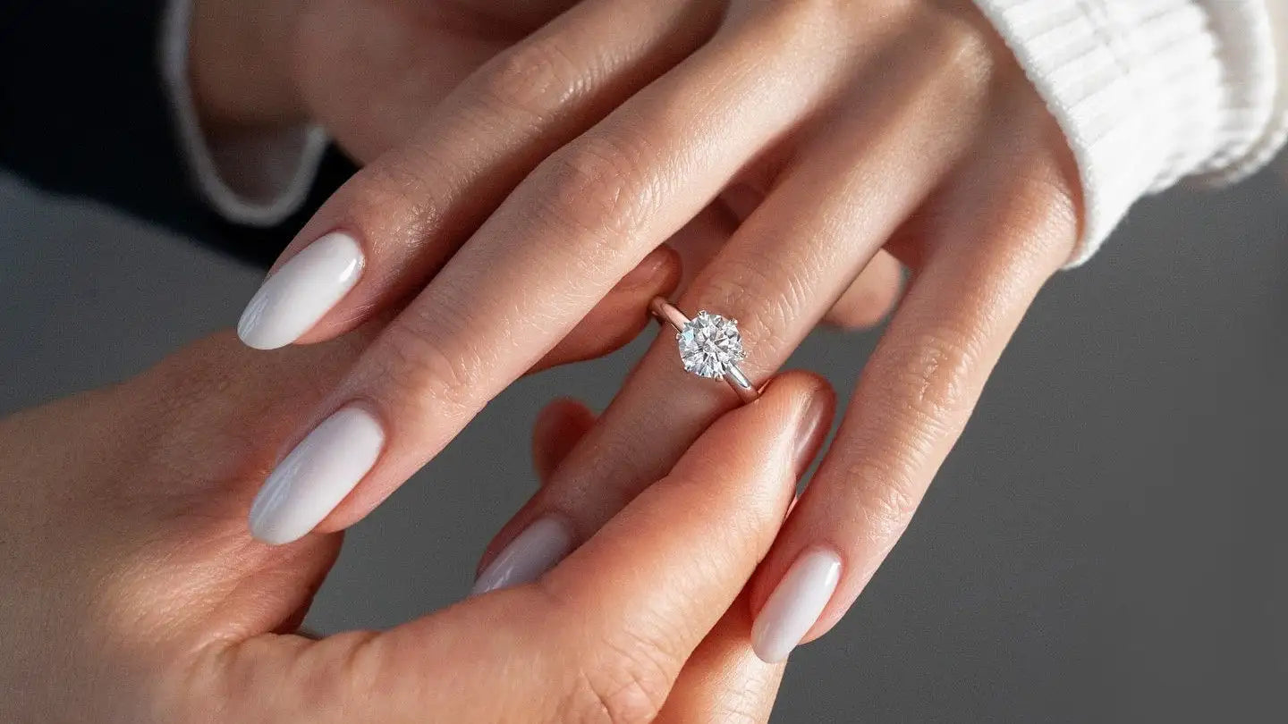 A delicate rose gold solitaire engagement ring featuring a sparkling round-cut diamond.