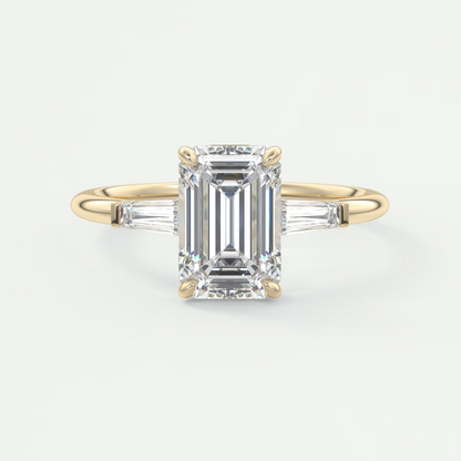 Custom made elysian emerald three-stone engagement ring with tapered baguettes