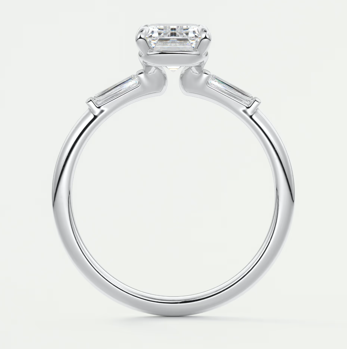 Custom made elysian emerald three-stone engagement ring with tapered baguettes