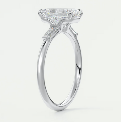 Custom made elysian emerald three-stone engagement ring with tapered baguettes