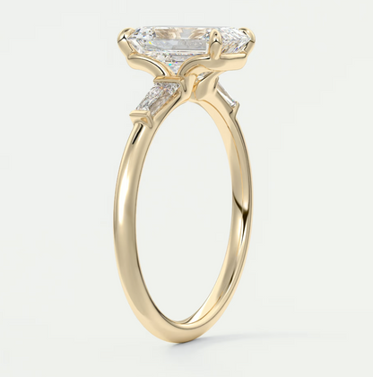 Custom made elysian emerald three-stone engagement ring with tapered baguettes