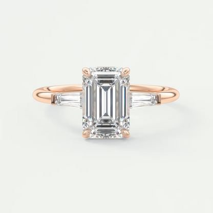 Custom made elysian emerald three-stone engagement ring with tapered baguettes