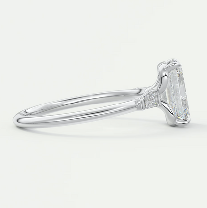 Custom made elysian emerald three-stone engagement ring with tapered baguettes