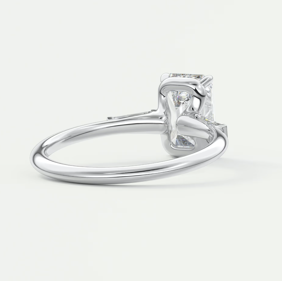 Custom made elysian emerald three-stone engagement ring with tapered baguettes