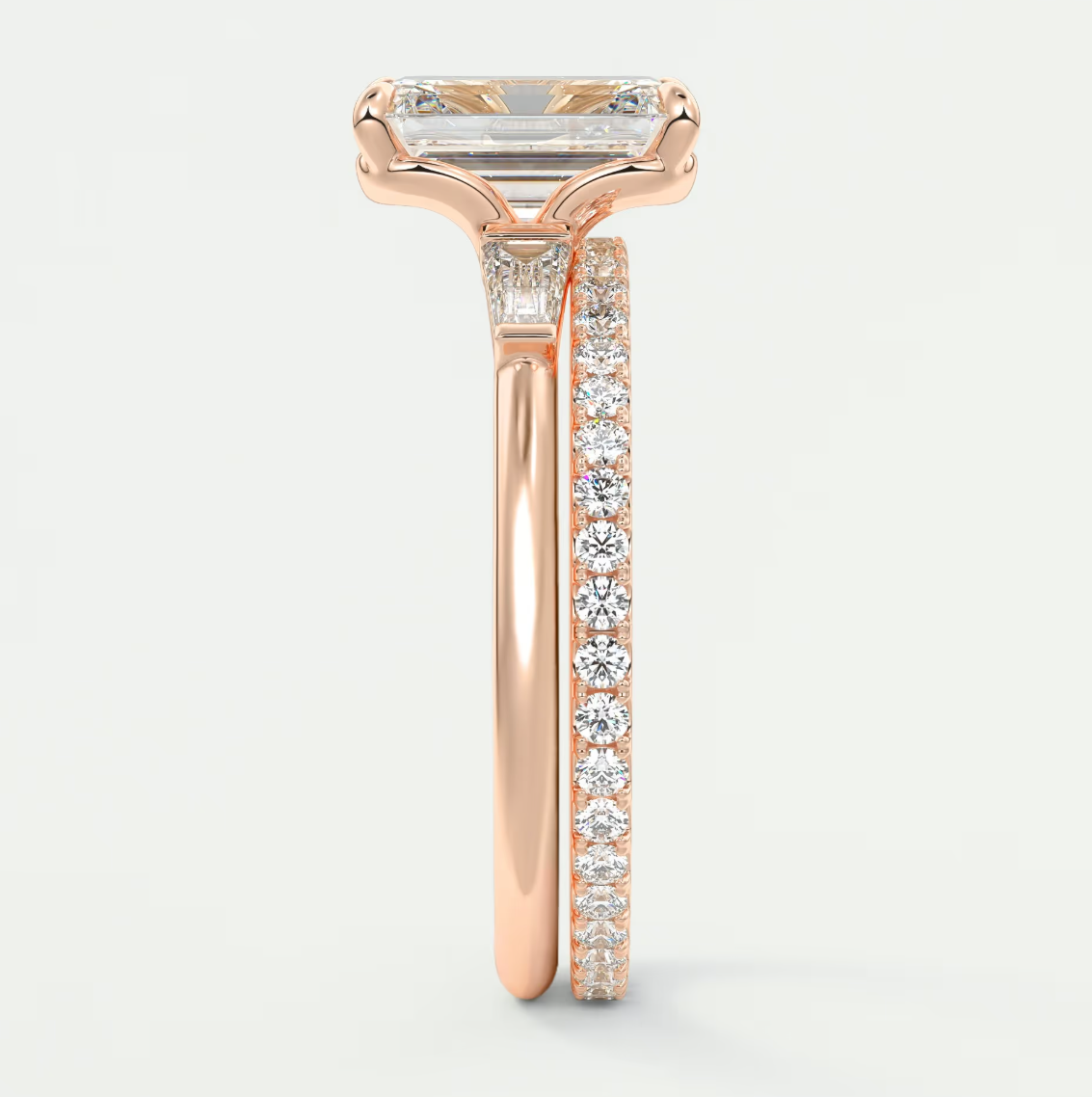 Custom made elysian emerald three-stone engagement ring with tapered baguettes