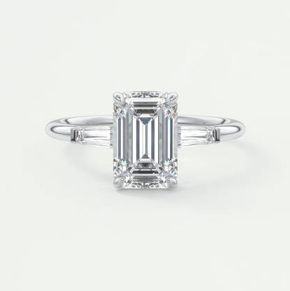 Custom made elysian emerald three-stone engagement ring with tapered baguettes