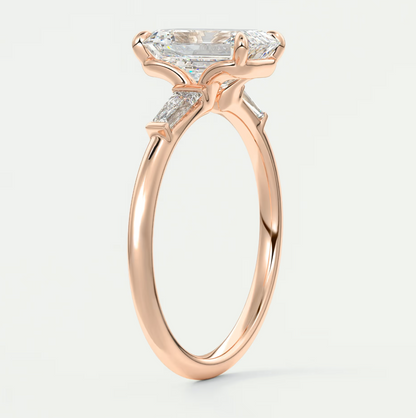 Custom made elysian emerald three-stone engagement ring with tapered baguettes