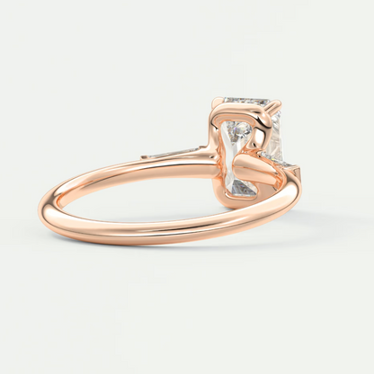 Custom made elysian emerald three-stone engagement ring with tapered baguettes