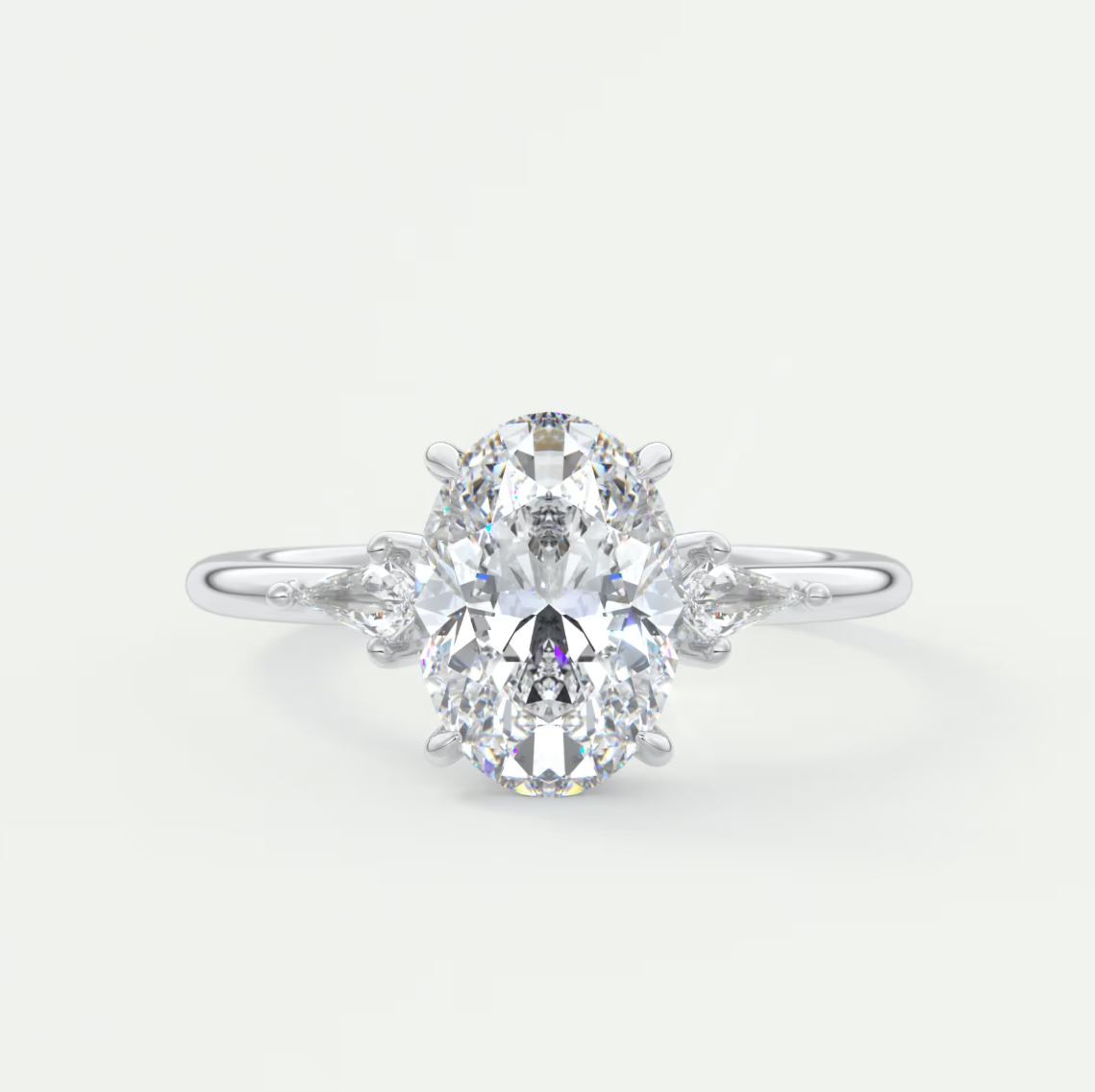 Custom made elysian oval three-stone engagement ring with kite side stones | diamond lab