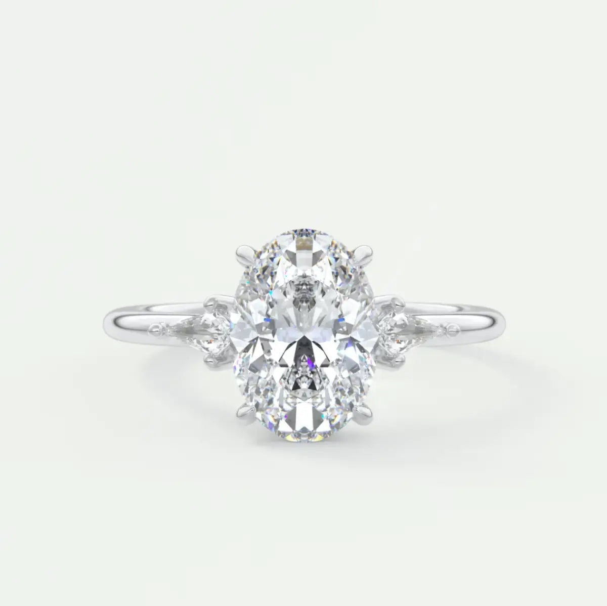 Custom made elysian oval three-stone engagement ring with kite side stones | diamond lab