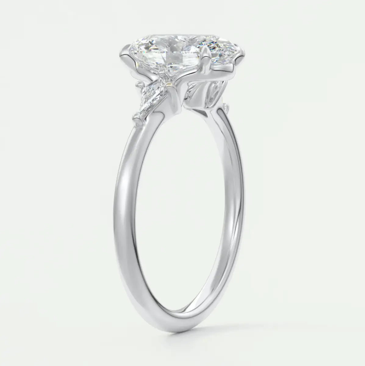 Custom made elysian oval three-stone engagement ring with kite side stones | diamond lab