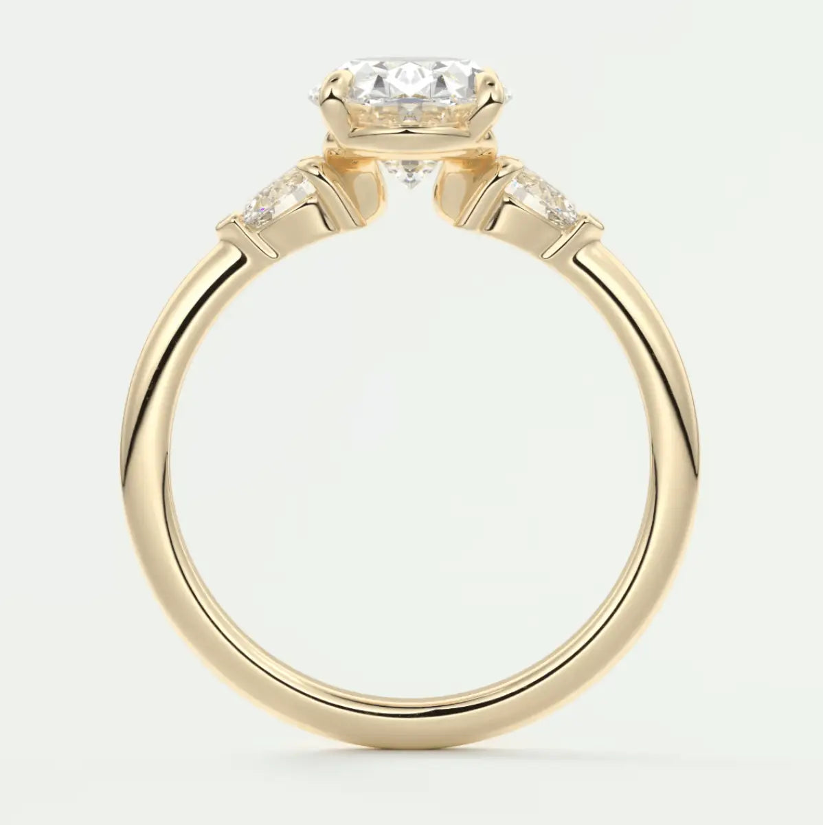 18k yellow gold engagement ring with a round diamond center stone and two smaller diamonds on each side.