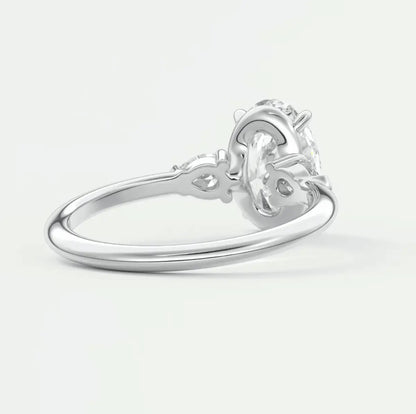 White gold engagement ring with a diamond center stone and floral detailing.