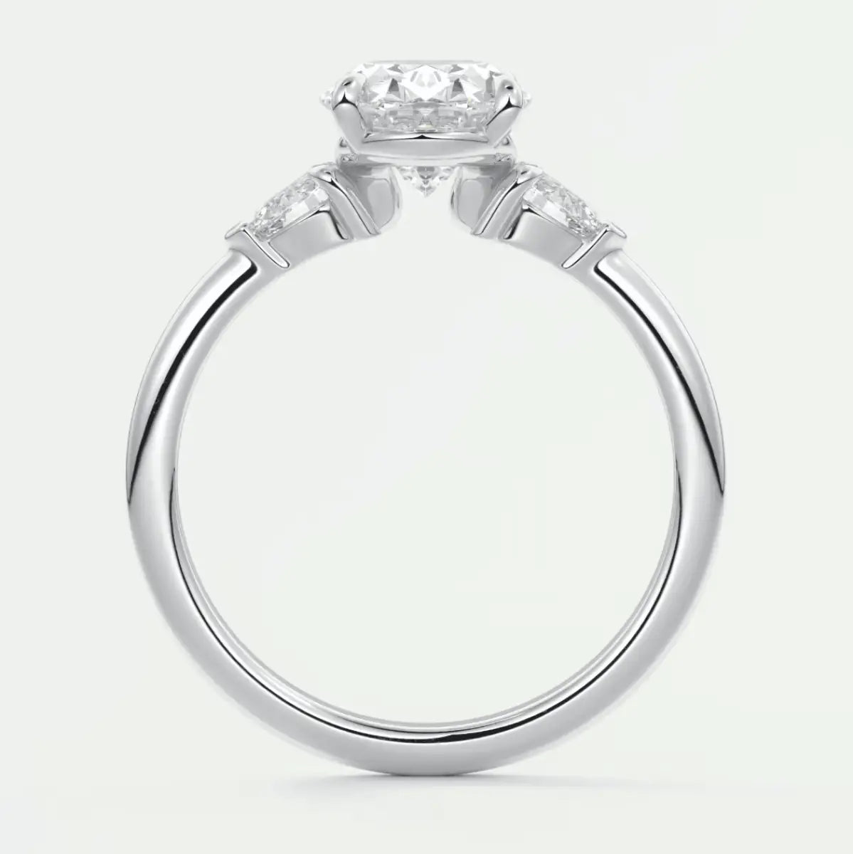 18k white gold engagement ring with a round diamond center stone and two smaller diamonds on each side.
