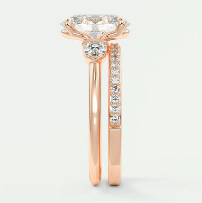 18k rose gold engagement ring with a round diamond center and pavé set diamonds on the band.