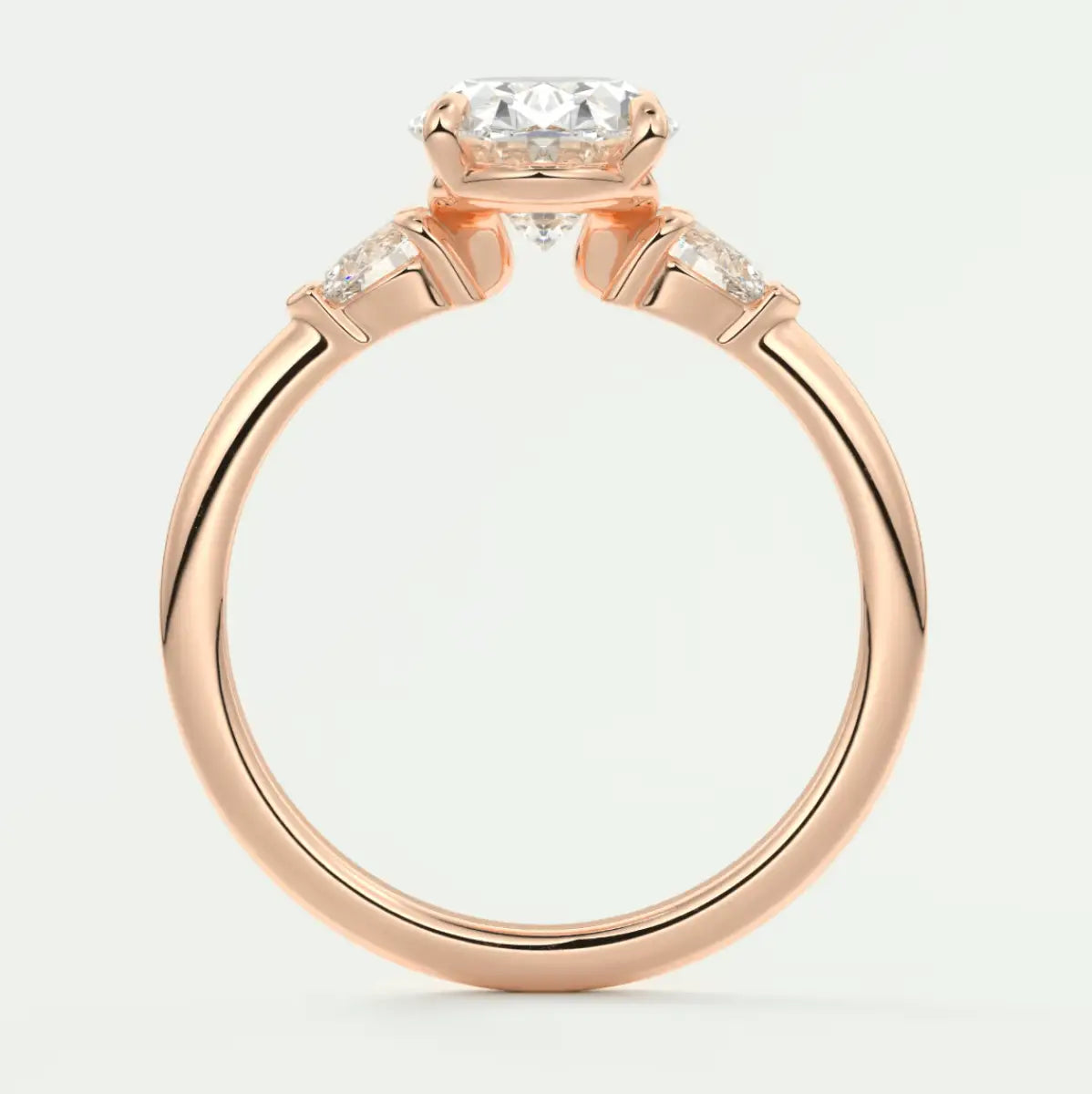 18k rose gold engagement ring with a cushion-cut diamond and two smaller diamonds on each side.