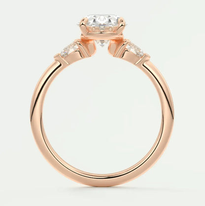 18k rose gold engagement ring with a cushion-cut diamond and two smaller diamonds on each side.