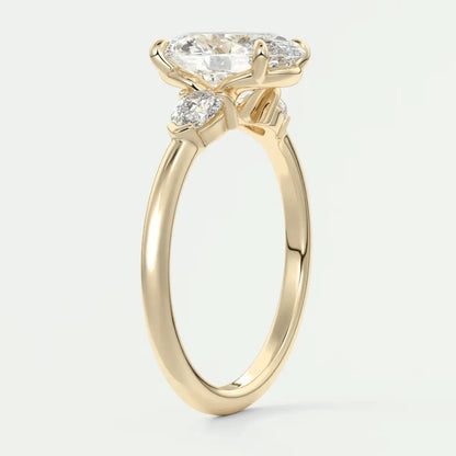 18-karat yellow gold engagement ring with a cushion-cut diamond and two smaller diamonds on each side.