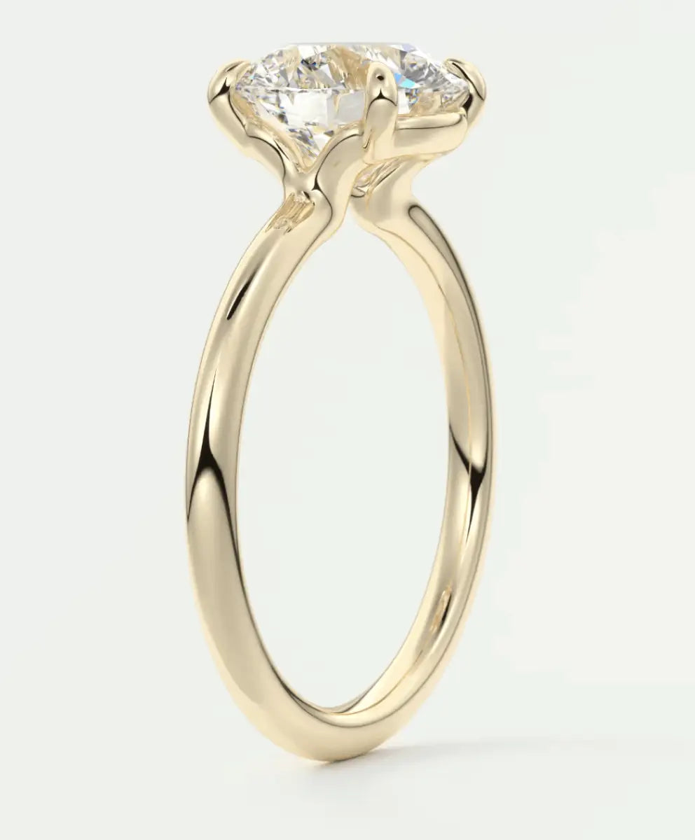 18-karat yellow gold engagement ring with a round diamond.